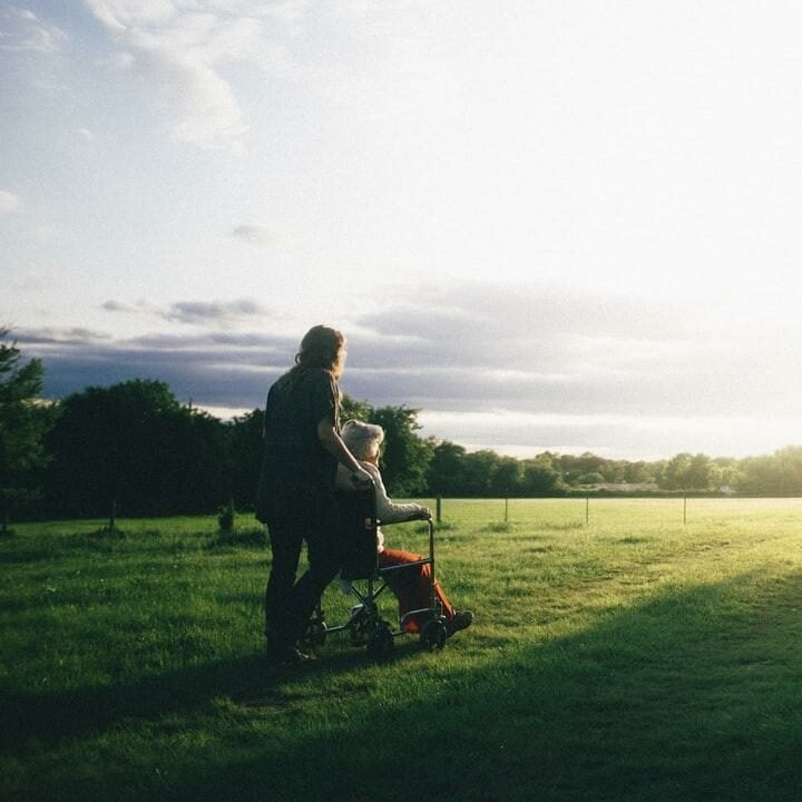 pushing grandmother in wheelchair